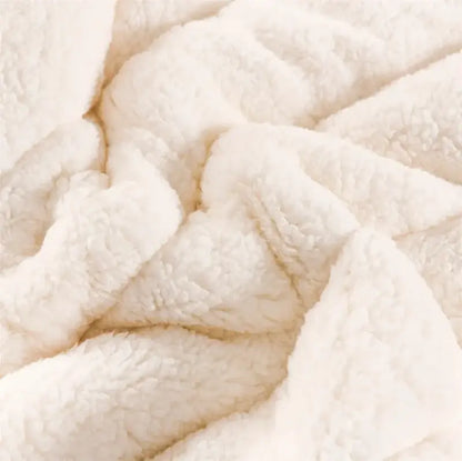 Cream-colored plush fleece blanket with soft textured surface from decorbites cozy coral fleece collection for bedroom decor