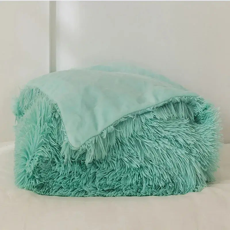 A cozy faux fur throw blanket in mint green with soft inner lining perfect for plush decorbites cozy faux decor