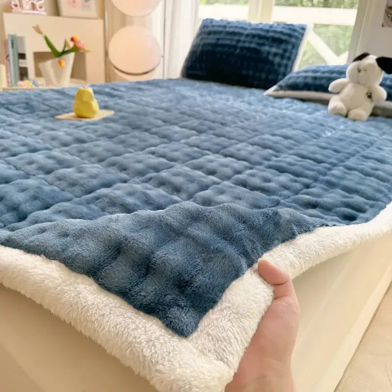 Blue quilted fleece bedspread with plush white border from decorbites cozy faux rabbit fur mattress pad collection
