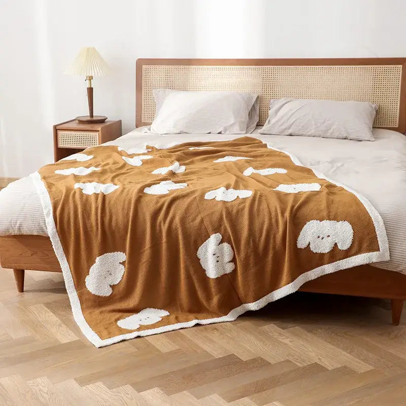 Cozy flannel blanket by decorbites featuring brown plush fabric with white fluffy puppy appliqués and matching white border