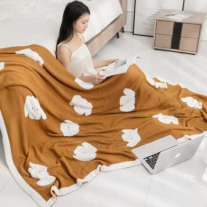 Warm caramel-colored decorbites cozy flannel blanket with plush white cloud motifs and soft cozy texture for bedroom use