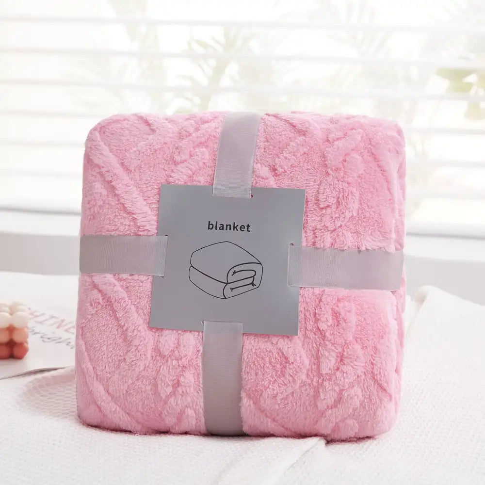 A soft pink decorbites cozy jacquard plush blanket with a textured fluffy surface for living room decor and sofa throws