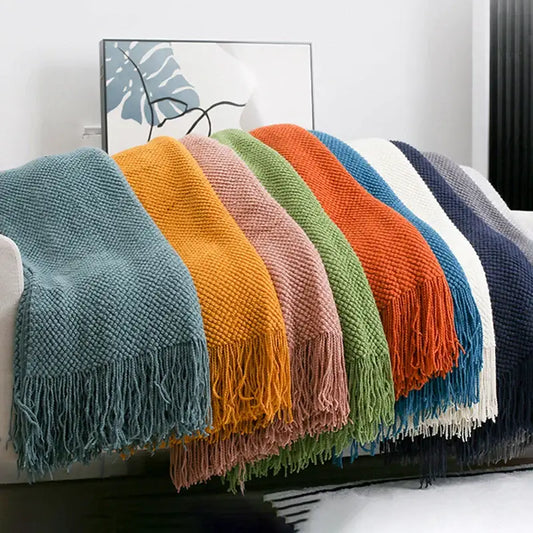 Cozy knitted sofa blanket with vibrant solid colors and textured knit featuring soft tassels for living room decorbites cozy knitted