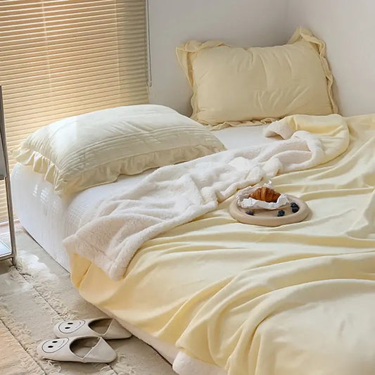 Cream-colored plush cozy lamb wool blanket with soft fluffy texture and ruffled edges for bedroom decorbites cozy lamb