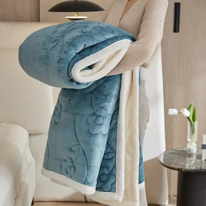 A plush teal blue wool sofa blanket with embroidered floral patterns and soft white sherpa lining by decorbites cozy