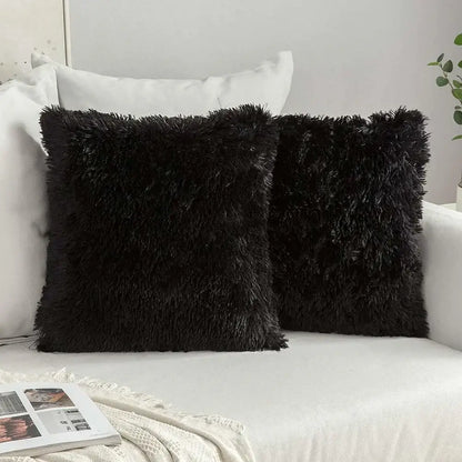 Two black fluffy faux fur throw pillows with shaggy texture for decorbites cozy plush cushion cover use