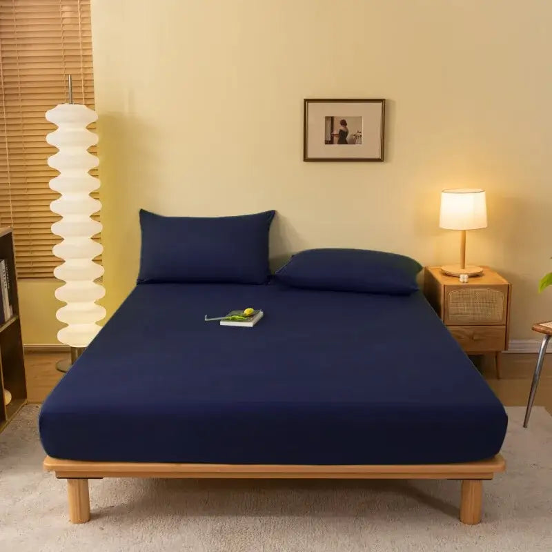 Deep navy blue decorbites cozy solid fitted sheet with smooth stretchy fabric snugly covering mattress and pillows