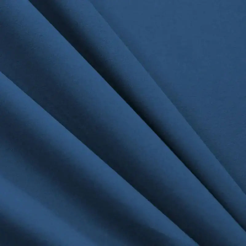 Cozy solid blue stretchy fitted sheet in deep navy blue fabric with soft texture and subtle folds for mattress cover decorbites