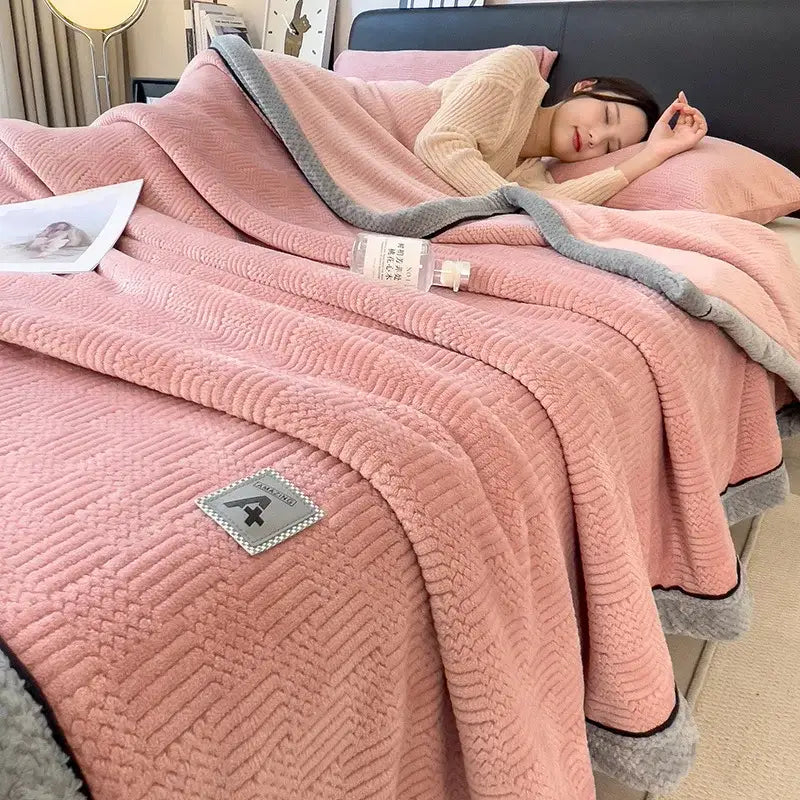 Pink plush blanket with gray border and textured weave featuring a small patch in decorbites cozy striped knitted velvet style