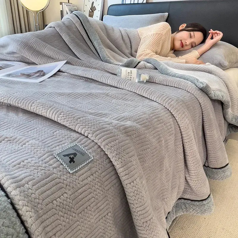 Soft gray quilted blanket with plush textured surface and subtle black piping for decorbites cozy striped velvet bedding