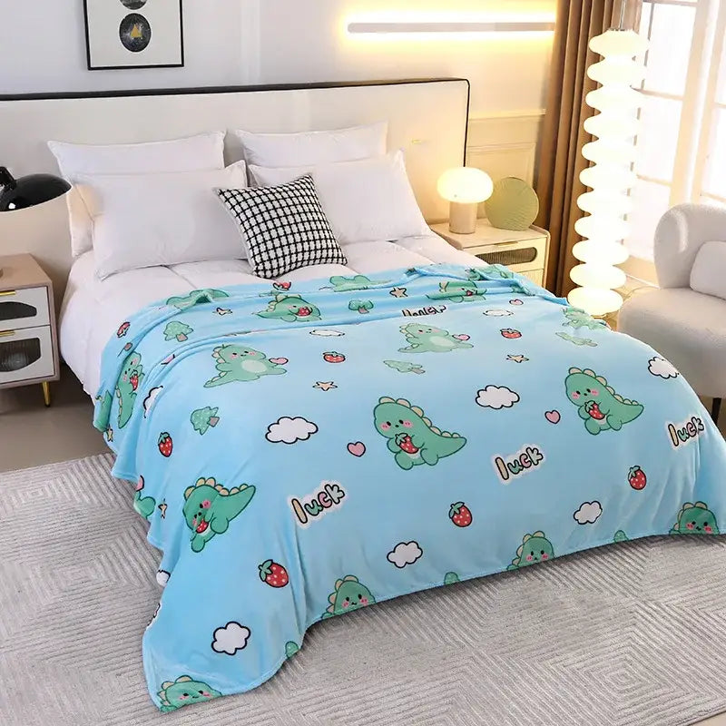 Light blue plush blanket with playful green dinosaurs and luck text paired with colorful flower patterns fleece decor
