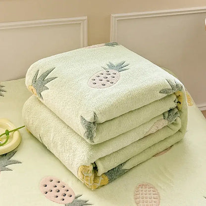 Cozy white fleece blanket with colorful flower patterns featuring a soft light green side embroidered with pineapples