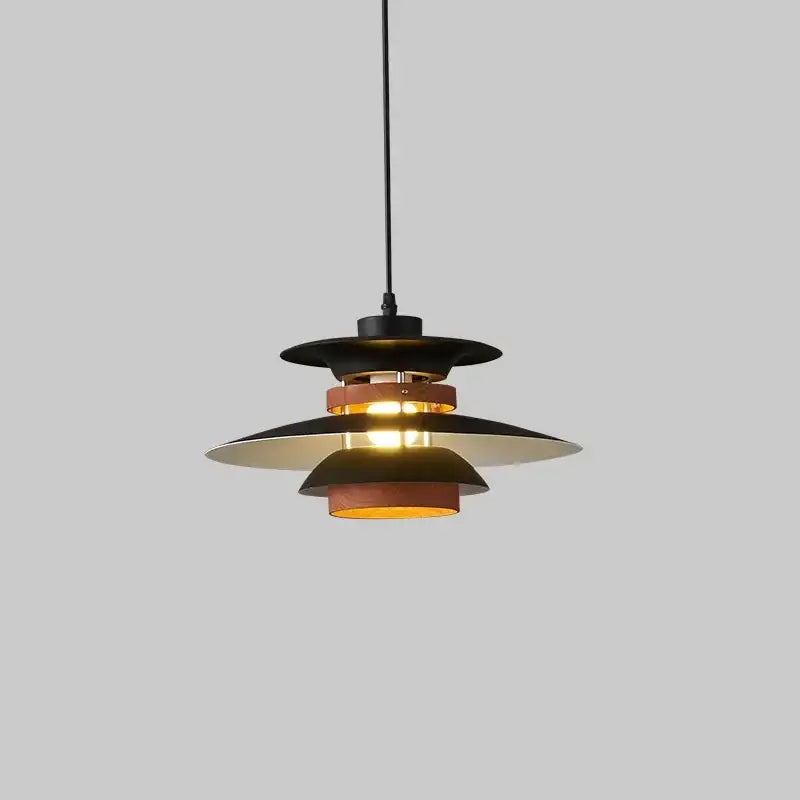 Black and brass layered pendant light with modern tiered design complementing decorbites colorful umbrella shape decor
