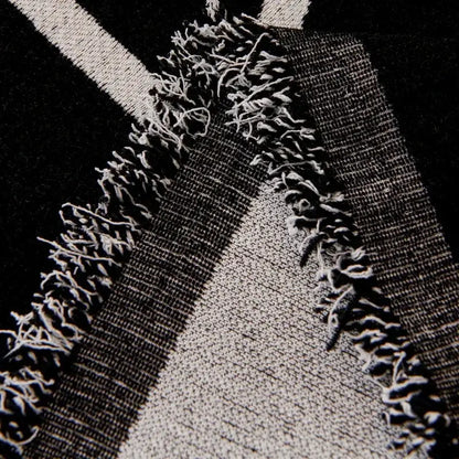Cream and black cat print chenille sofa cover with black and white striped textile and frayed edges for living room use