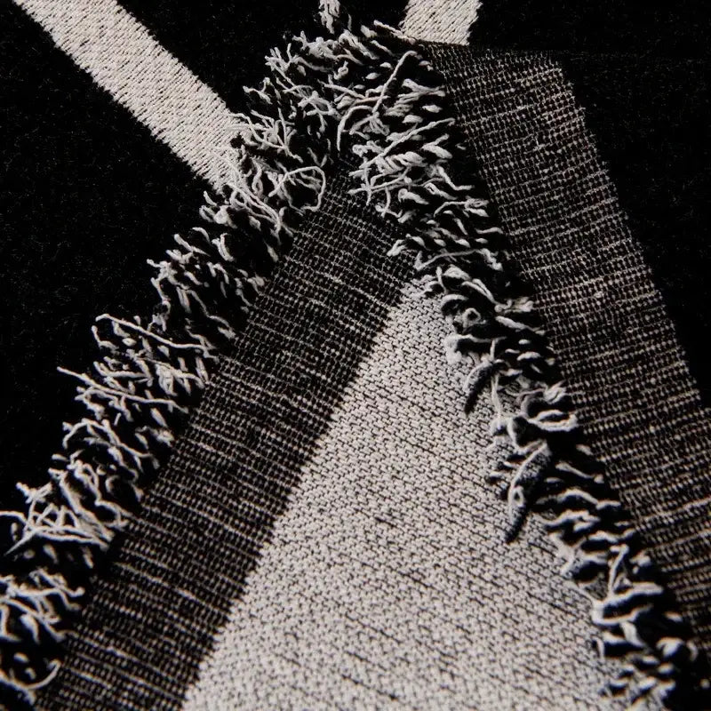 Cream and black cat print chenille sofa cover with black and white striped textile and frayed edges for living room use