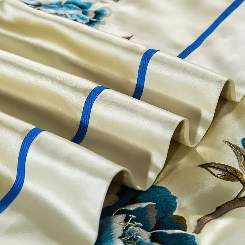 Cream and blue 200s embroidery egyptian cotton bedding set with satin bedsheet featuring blue floral embroidery and ribbed trim