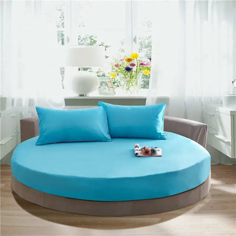 Cream and gray round fitted bed with turquoise fitted bed sheet and matching pillows for bedroom decor
