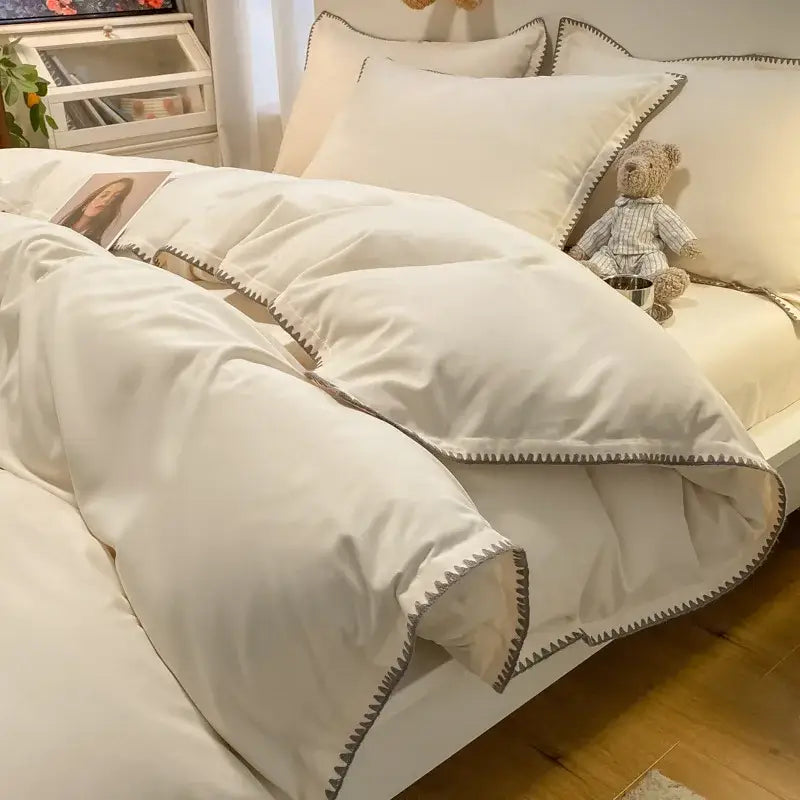 Cream and gray zigzag quilted bedding set with cozy shell edges featuring cream-colored fabric and subtle gray stitch decorbites cozy shell