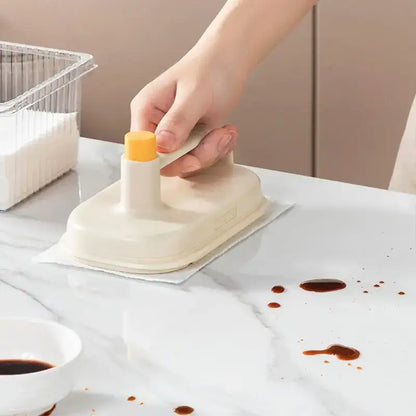 Cream and yellow silicone kitchen cleaning brush with replaceable head and bright yellow handle for easy kitchen cleaning