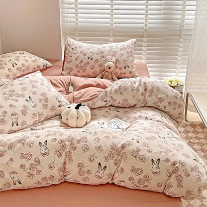 Pastel pink and cream cotton bedding set with decorbites cartoon pattern featuring bunnies and roses