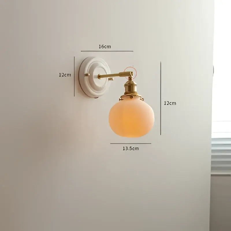 Cream ceramic led wall light with copper arm and vintage-style brass sconce featuring frosted peach glass globe decorbites ceramic led wall light