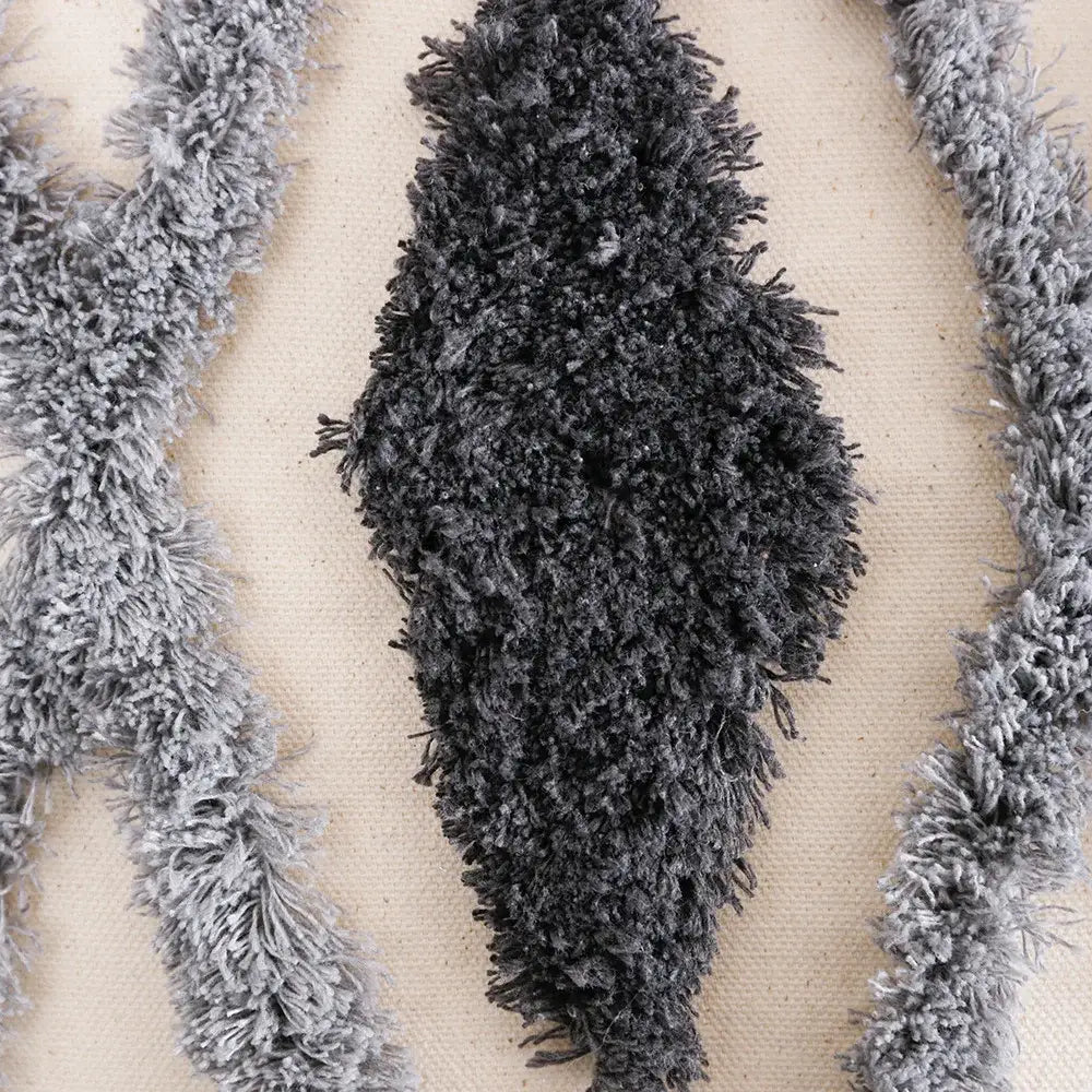 Dark gray fluffy textured fringe trim on cream and charcoal grey geometric tufted cushion cover for living room decorbites decor