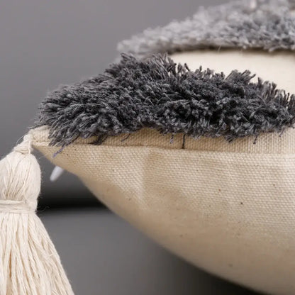 Beige canvas cushion cover with dark gray shaggy fringe and cream tassel for decorbites grey geometric tufted decor