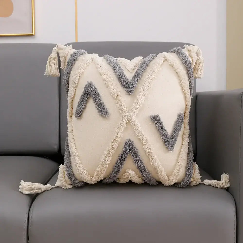 Cream-colored cushion cover with gray geometric tufted embroidery and tassels for decorbites grey geometric decor