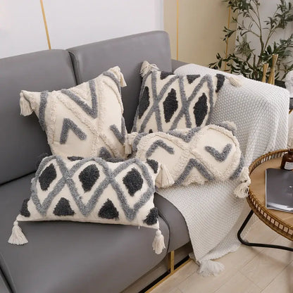 Set of three cream and charcoal grey geometric tufted cushion covers with textured fabric and tassels for living room decorbites decor