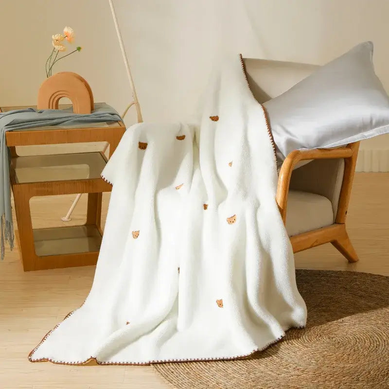Cream cherry velvet embroidered velvet embroidered blanket with white plush, brown cat faces, and brown fringe pom pom throw