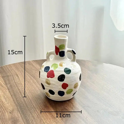 A cream colorful dot ceramic pitcher vase with two handles in red green black gold and blue for kitchen decorbites decor
