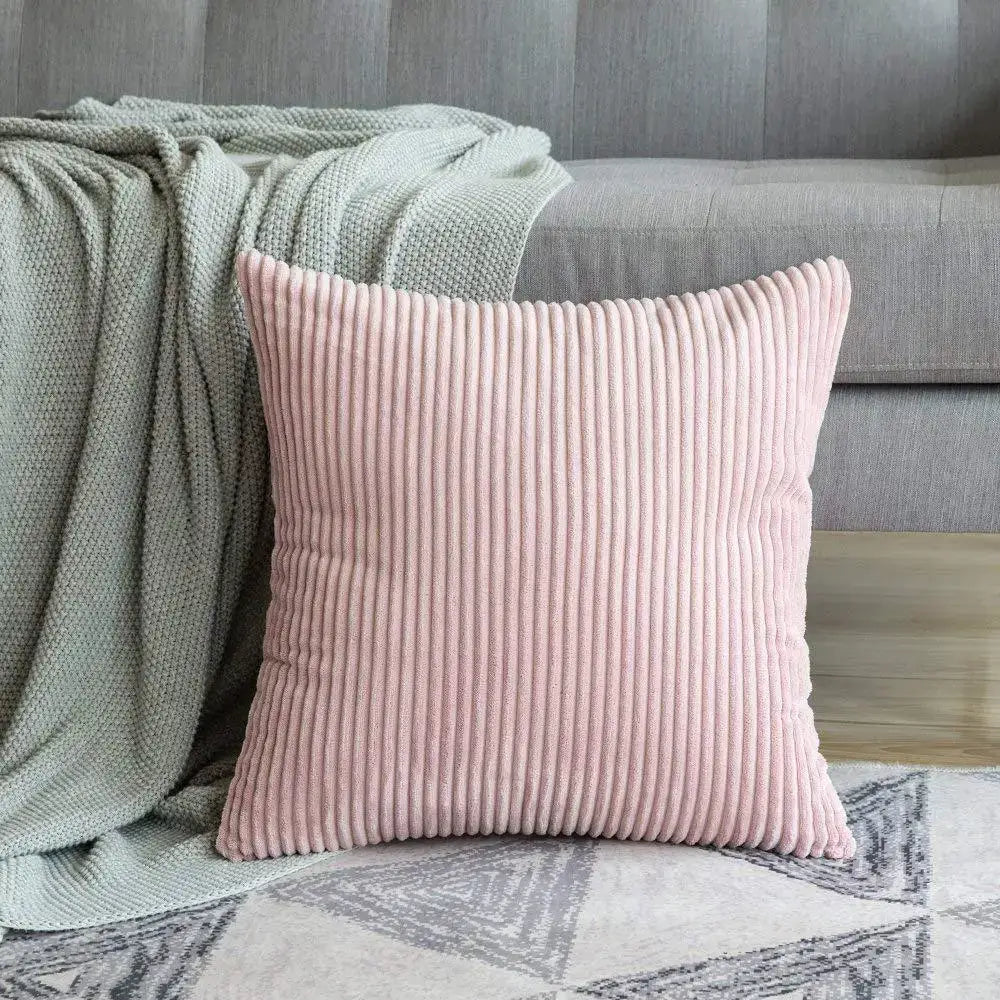 A soft pink corduroy striped cushion cover with vertical ridges decorbites corduroy striped cushion on patterned rug