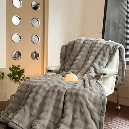 A plush gray throw blanket with soft fuzzy surface and subtle ribbed pattern from decorbites cozy bubble faux rabbit fur collection