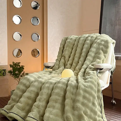 Cream cozy bubble faux rabbit fur blanket with light green ribbed throw and black trim for decorbites cozy bubble use
