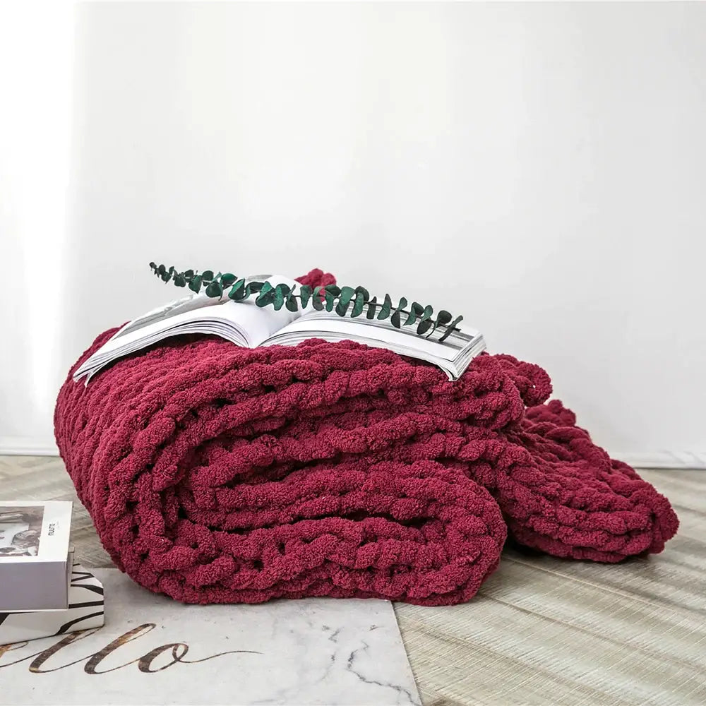 A plush deep red chenille chunky knit throw blanket with a cozy textured appearance for decorbites cozy chenille decor