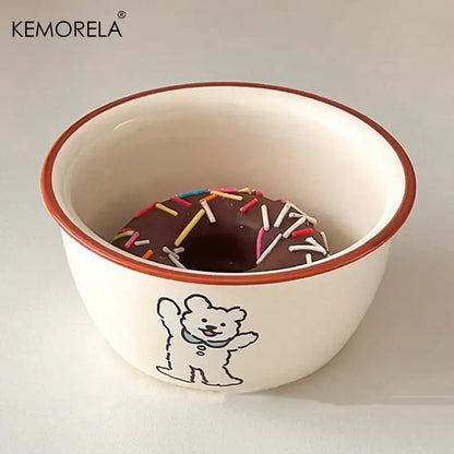 White ceramic carton ceramic soup bowl with brown rim and waving bear illustration holding a chocolate donut with sprinkles