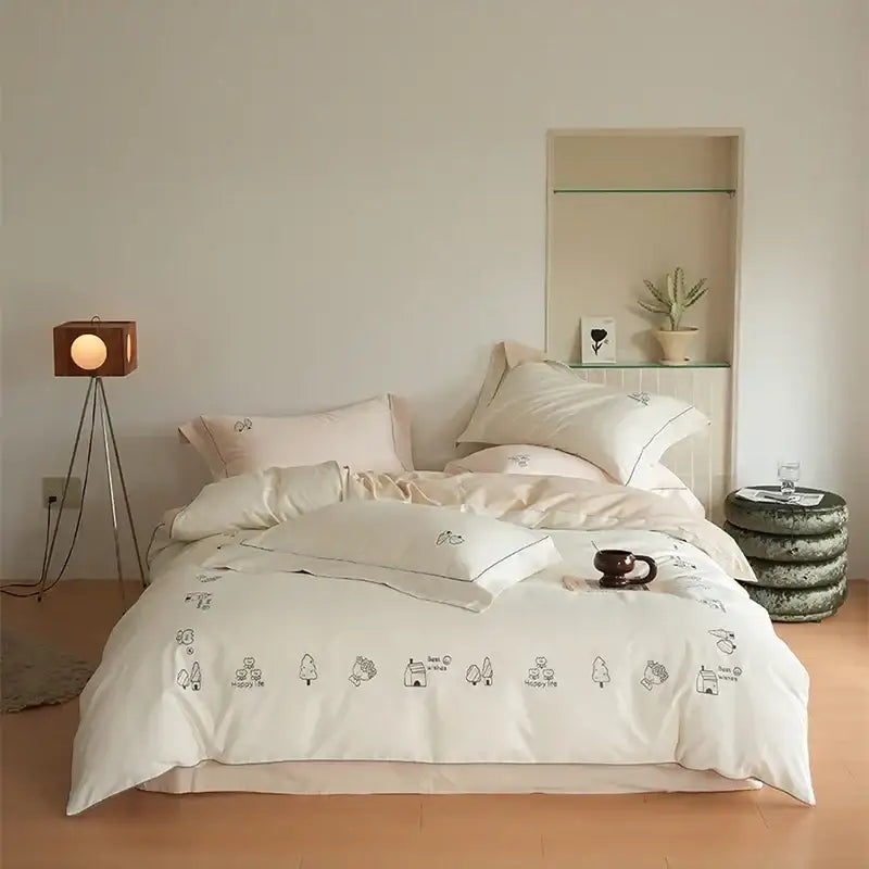 Cream embroidered brushed volcanic fleece bedding set in cream with delicate black tree and animal illustrations along edge