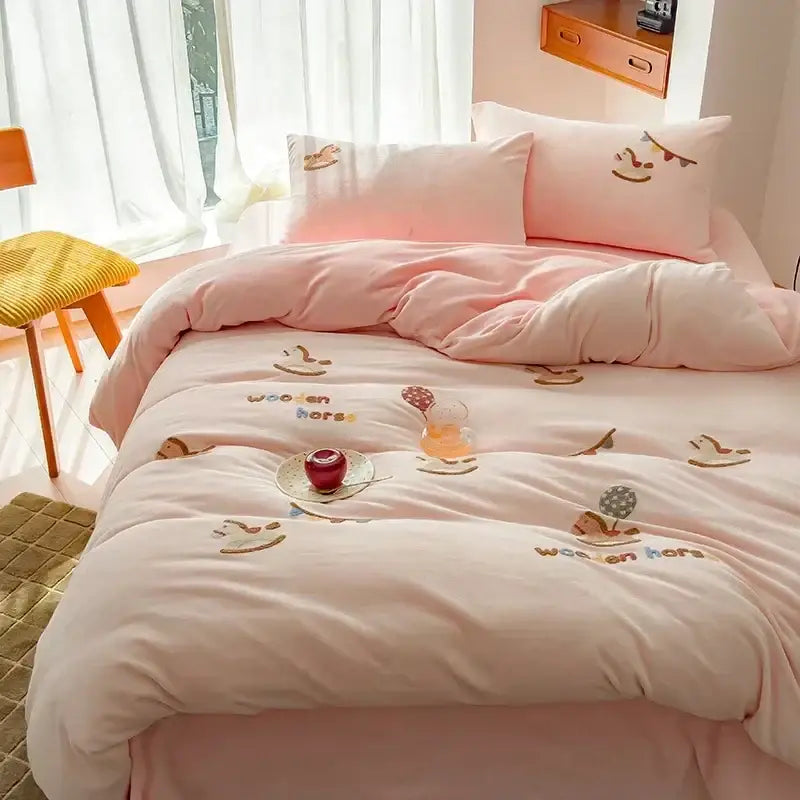 Pink plush duvet bedding set with embroidered wooden horse designs made of soft milk fleece material