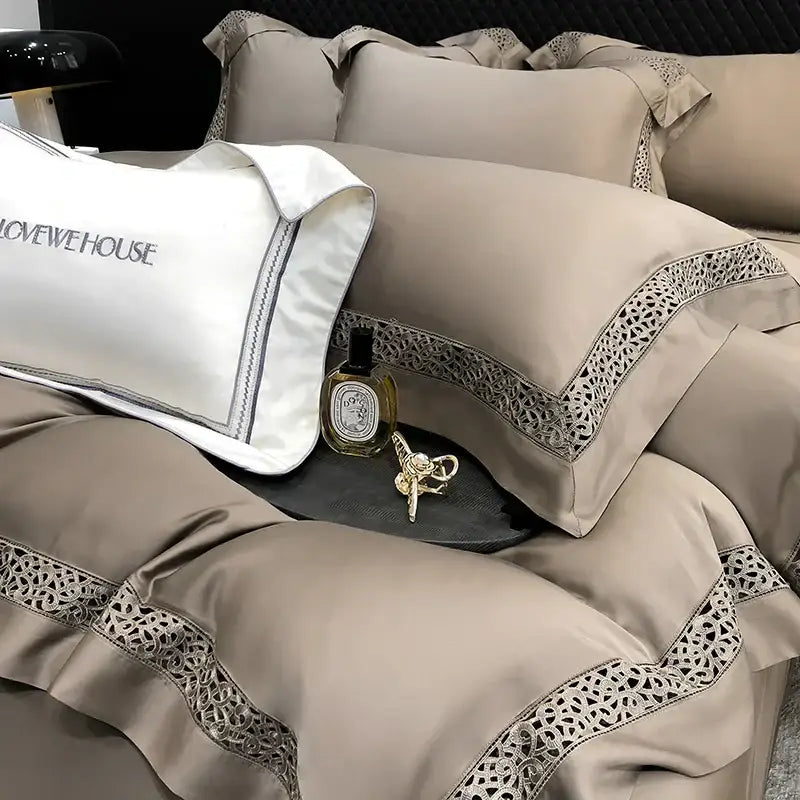 Beige satin bedding set with intricate lace trim and white embroidered pillow in cream decorbites eucalyptus lyocell 1000tc