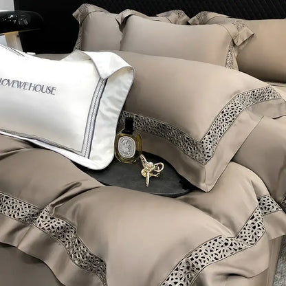 Beige satin bedding set with intricate lace trim and white embroidered pillow in cream decorbites eucalyptus lyocell 1000tc