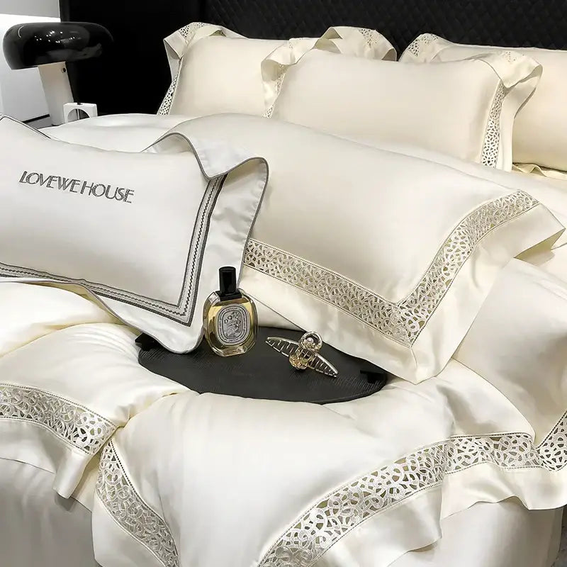 Cream eucalyptus lyocell 1000tc bedding set with cream satin pillowcases featuring silver lace trim and embroidered lovewehouse branding