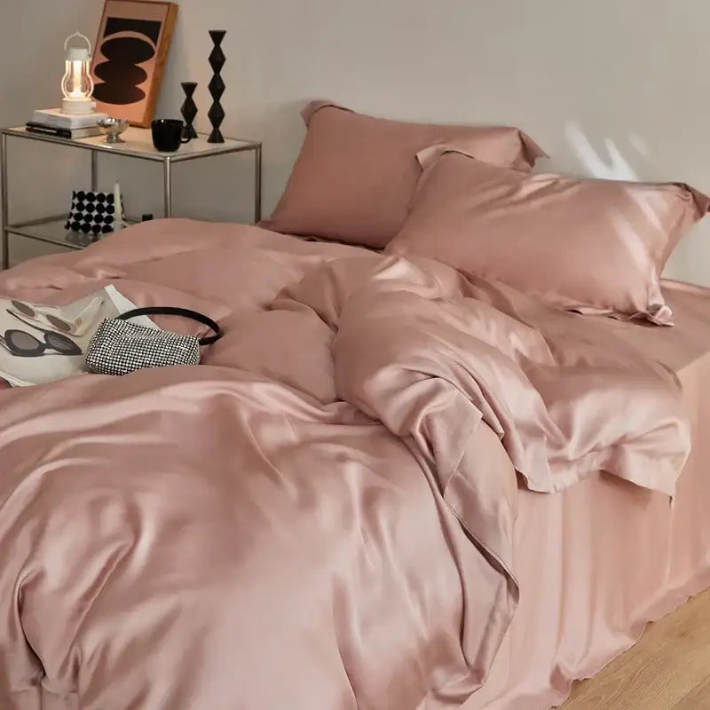 A soft blush pink satin bedding set with a glossy finish made from decorbites eucalyptus lyocell luxury fabric