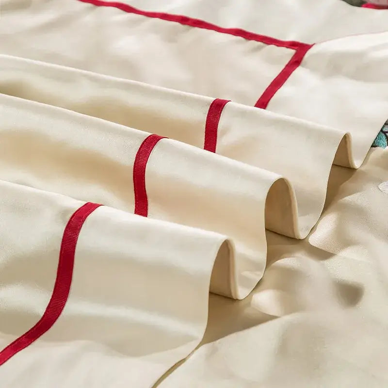 Cream floral 200s embroidery egyptian cotton bedding set featuring a cream satin pillowcase with bold red piping edges
