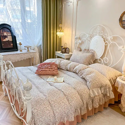 White wrought iron bed frame with ornate scrollwork paired with cream floral double layer lace ruffles bedding set