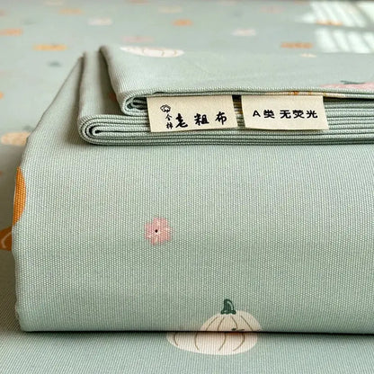A soft mint-green cotton bed cover with subtle embroidered pumpkins and flowers flower print by decorbites cooling cotton