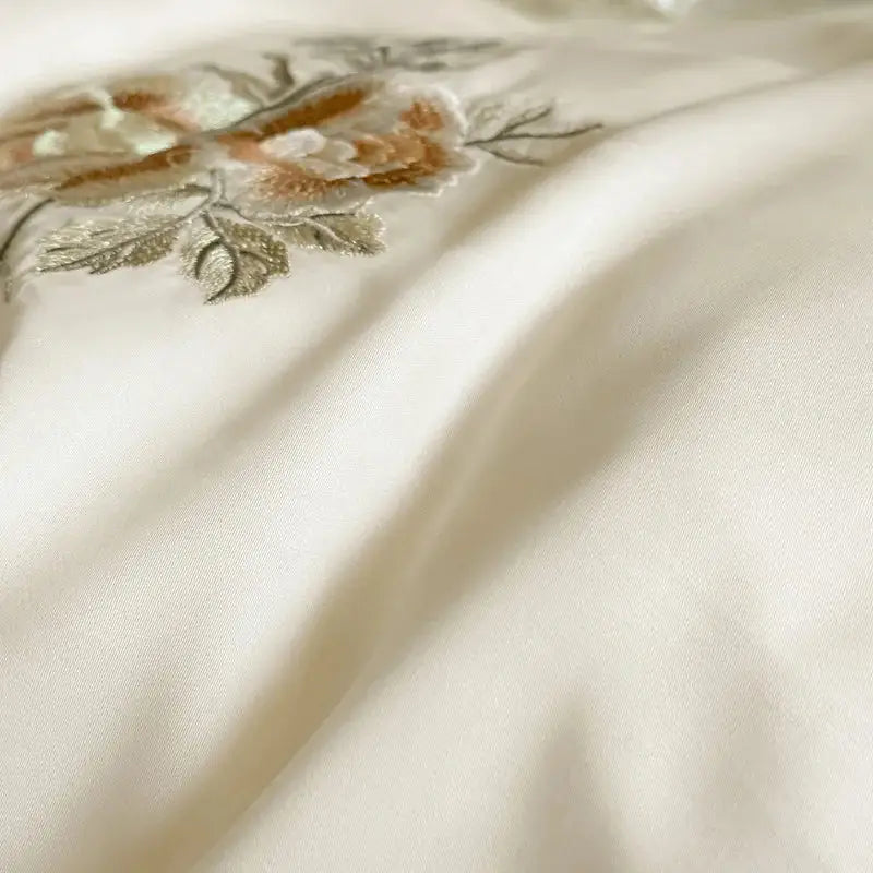 Cream flowers embroidery lace ruffles bedding set in cream satin lyocell with delicate gold beige and silver floral decorbites embroidery