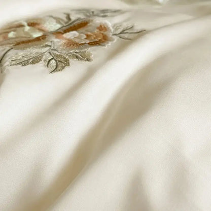 Cream flowers embroidery lace ruffles bedding set in cream satin lyocell with delicate gold beige and silver floral decorbites embroidery