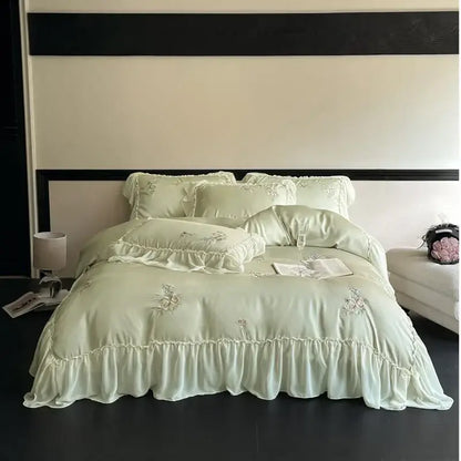 A delicate mint green satin lyocell bedding set with cream flowers embroidery and lace ruffles for elegant decorbites decor