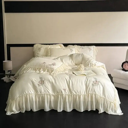 Cream-colored satin lyocell bedding set with decorbites flowers embroidery and delicate lace ruffles for bedroom use
