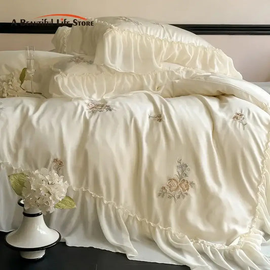 Cream-colored satin lyocell bedding set with delicate decorbites flowers embroidery and elegant lace ruffles edges